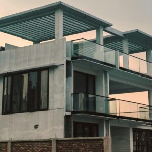 Contemporary multi-storey building with glass features in urban setting.