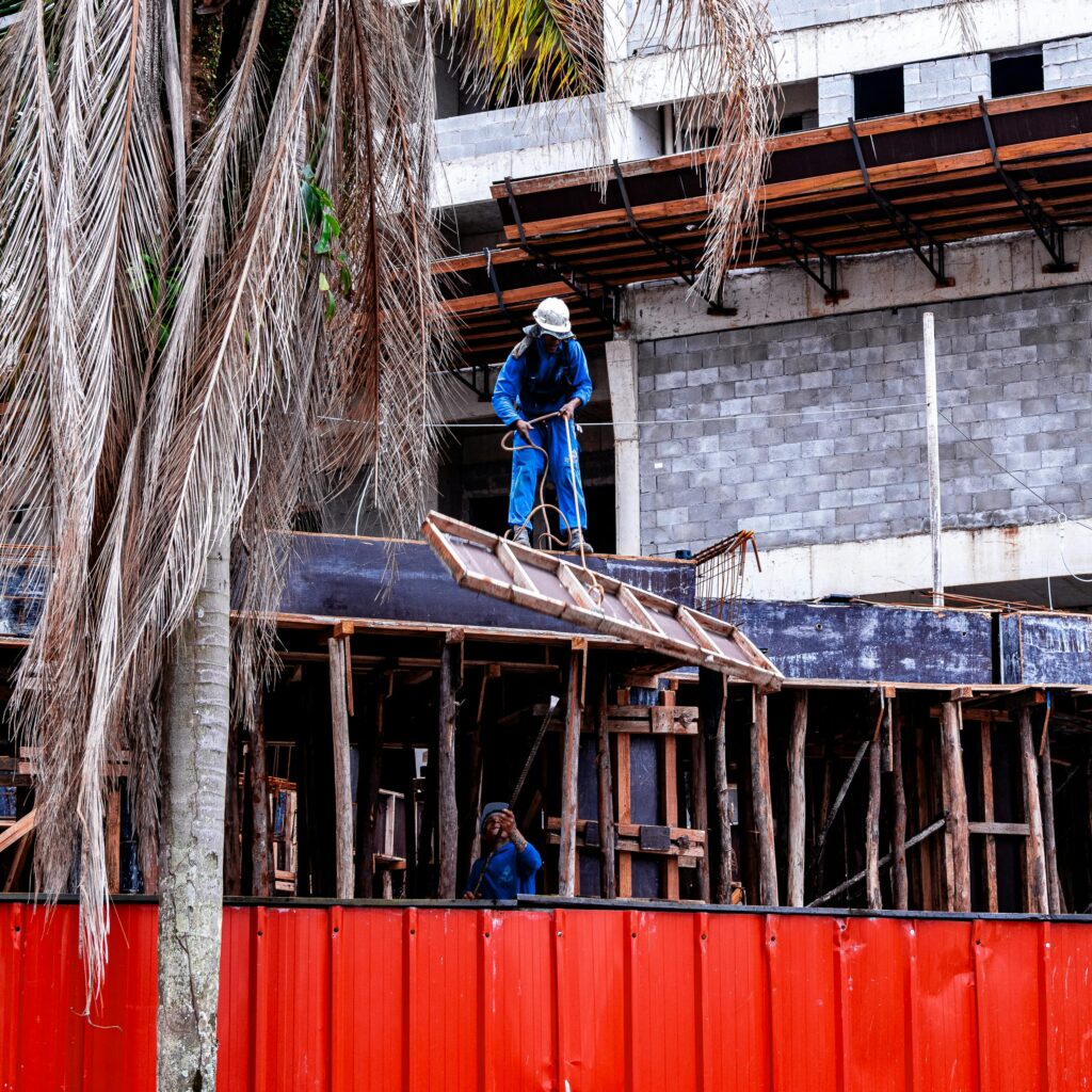 Construction workers on scaffolding at a building site in Praia Grande, São Paulo, Brazil.